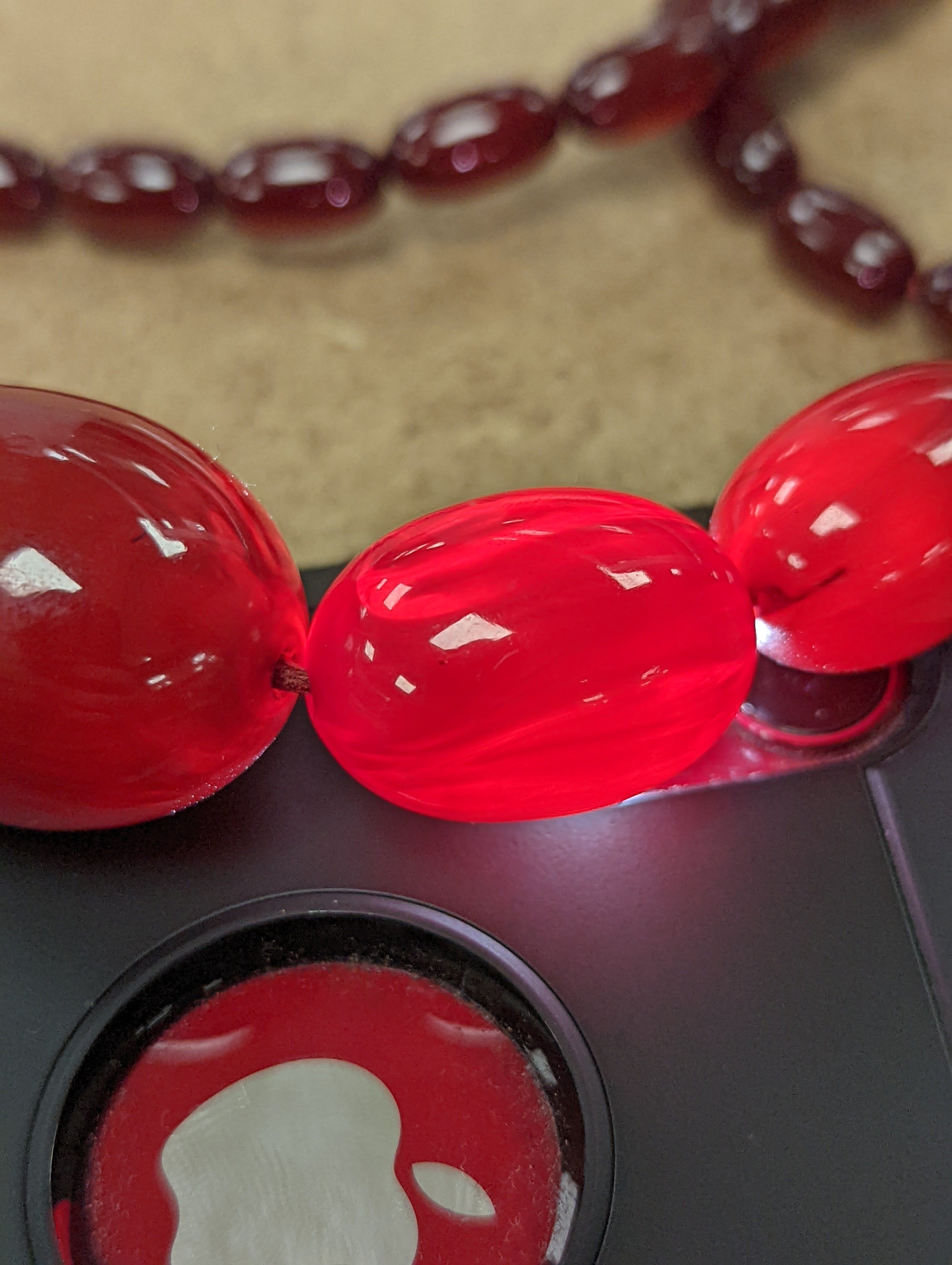 A single strand graduated simulated cherry amber bead necklece, 72cm, gross weight 63 grams.